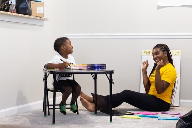 Child laughing with teacher